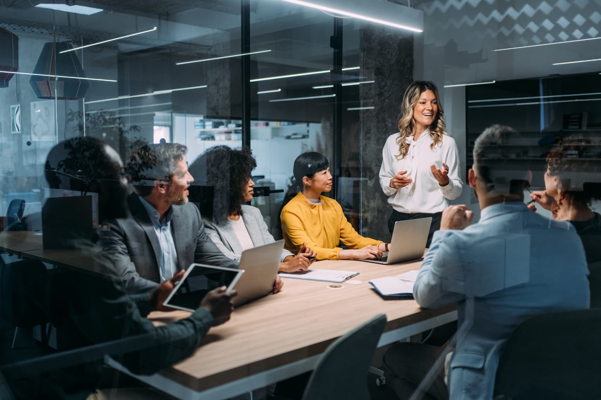 Leader presenting to colleagues around a boardroom table